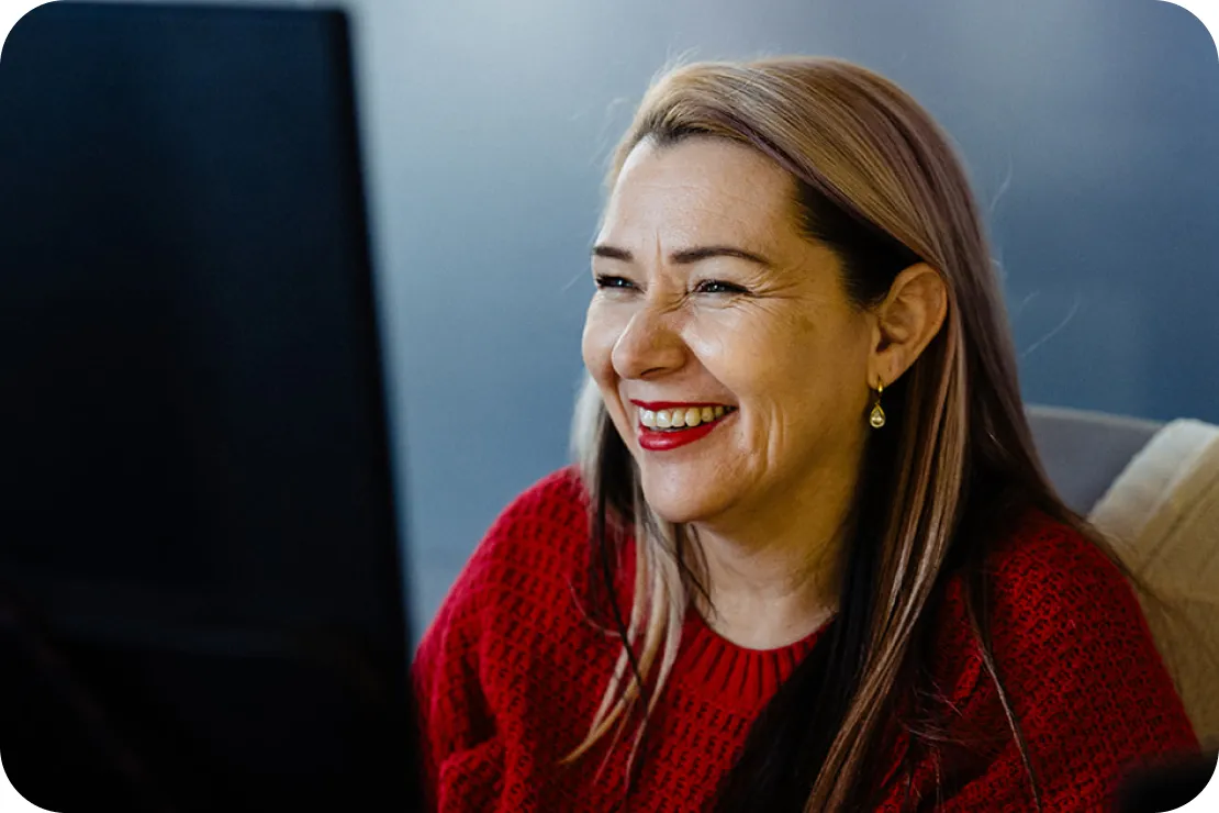 An Equity Guide smiling at her laptop