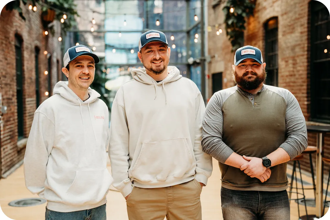 Three Equity Guides outdoors in matching Beeline caps